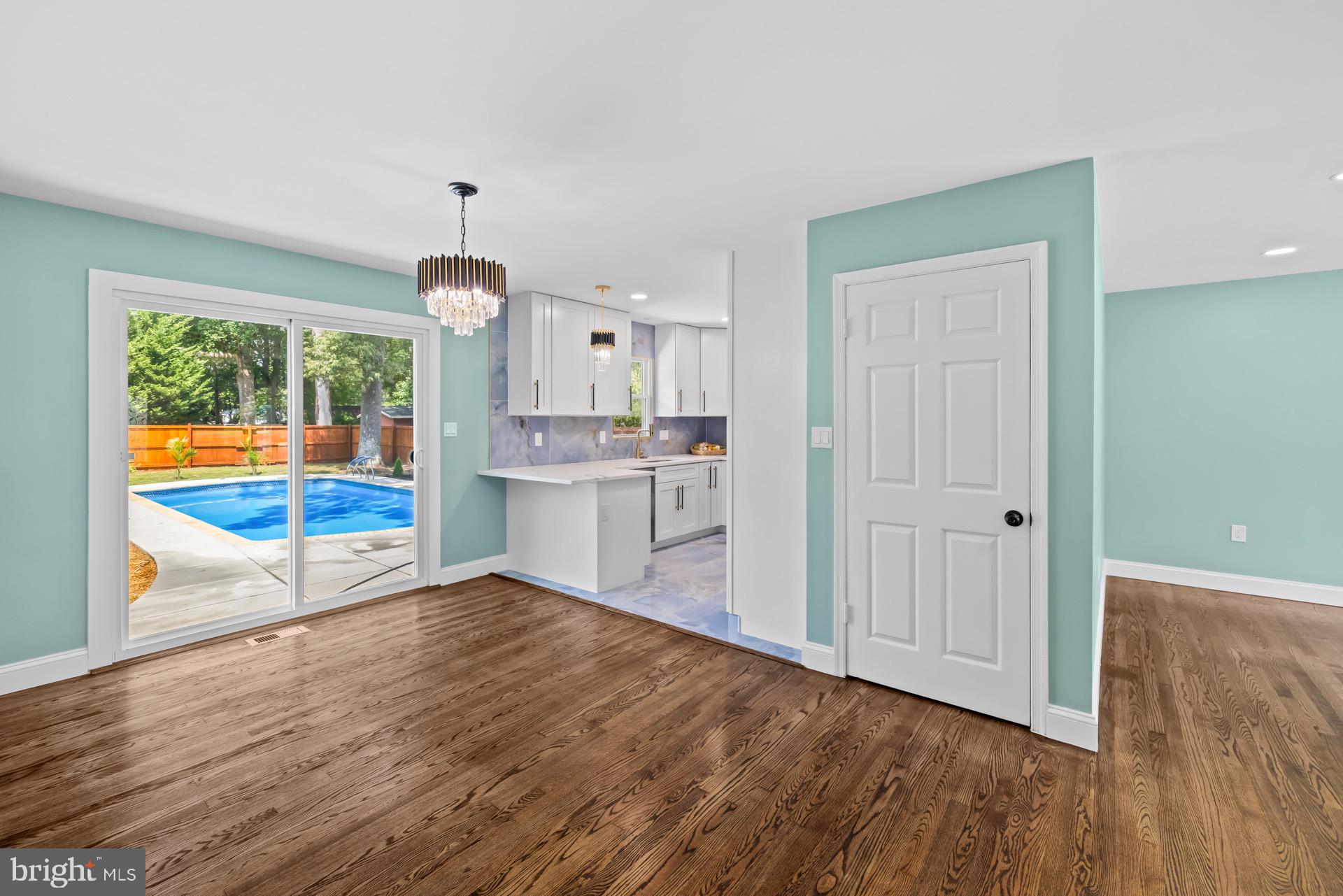 523 Sunset Knoll Road Pasadena, MD 21122 - Photo 10 of 60 a view of a kitchen with wooden floor and a window