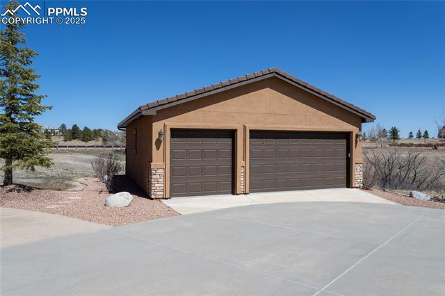 7249 Forestgate Road Colorado Springs, CO 80908 - Photo 1 of 4 Tandem 6 car detached garage is all finished, has epoxy flooring and a heater!