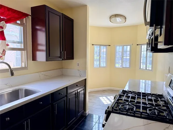 a kitchen with a sink stove and cabinets