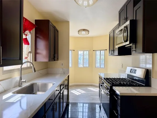 a kitchen that has a sink and a stove