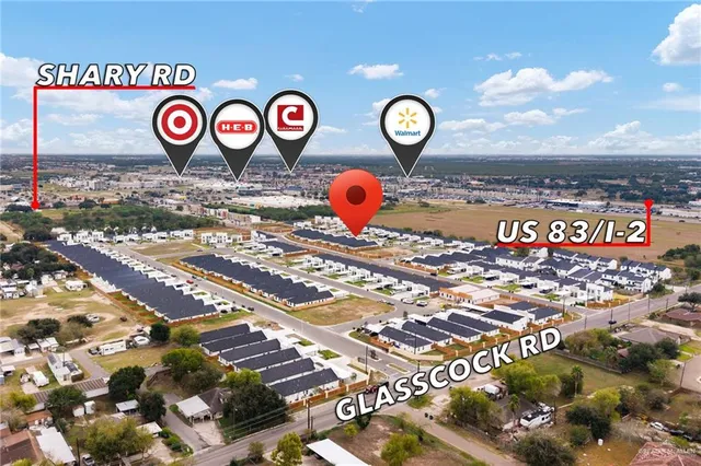 an aerial view of a house with a yard