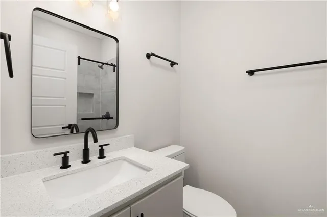 an empty room with closet and windows