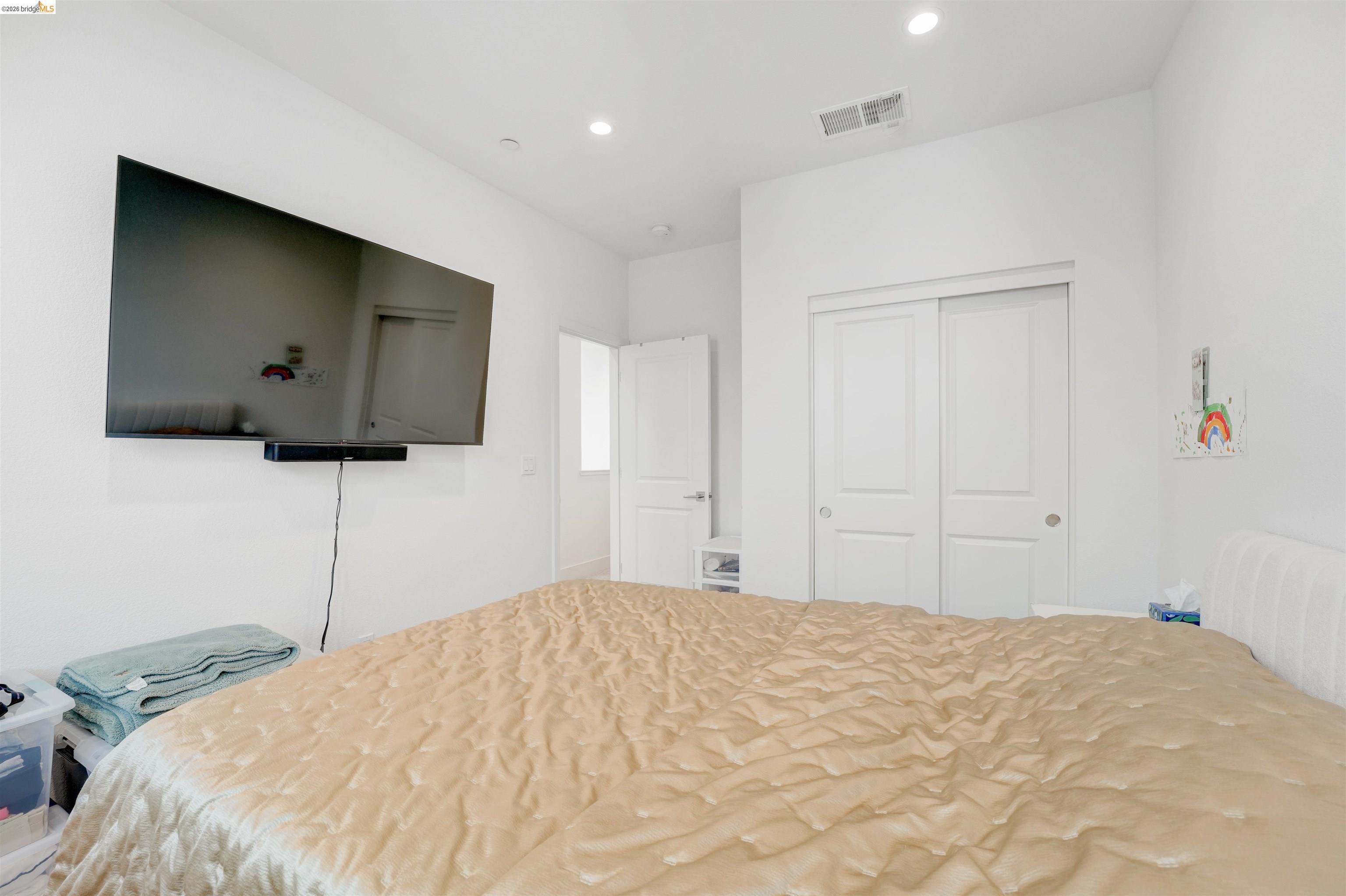 7101 Melon Court San Ramon, CA 94583 - Photo 39 of 58 a bedroom with a bed and a flat screen tv