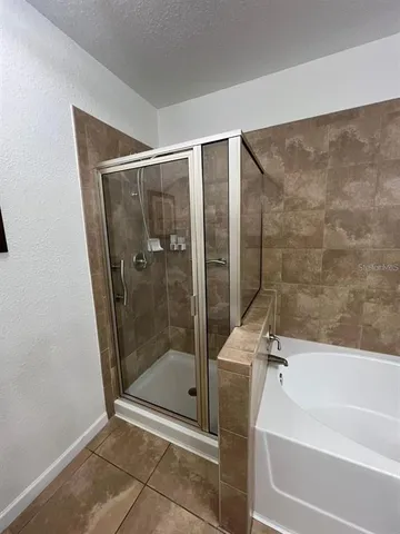 a bathroom with a shower and a bathtub