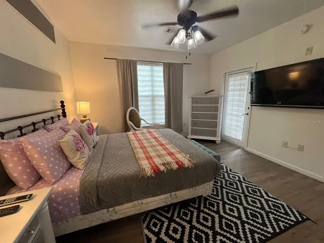 a bed sitting in a bedroom and flat screen tv