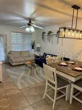 a living room with couches and piano