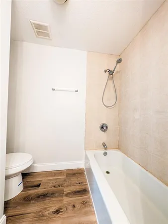 a bathroom with a bathtub and a toilet