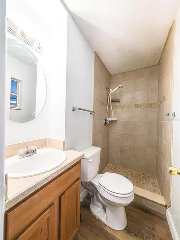a bathroom with a sink a toilet and shower