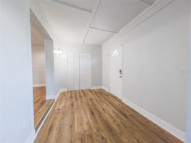 a view of hallway with wooden floor