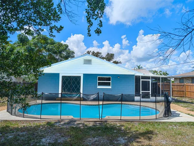 a view of a house with a backyard