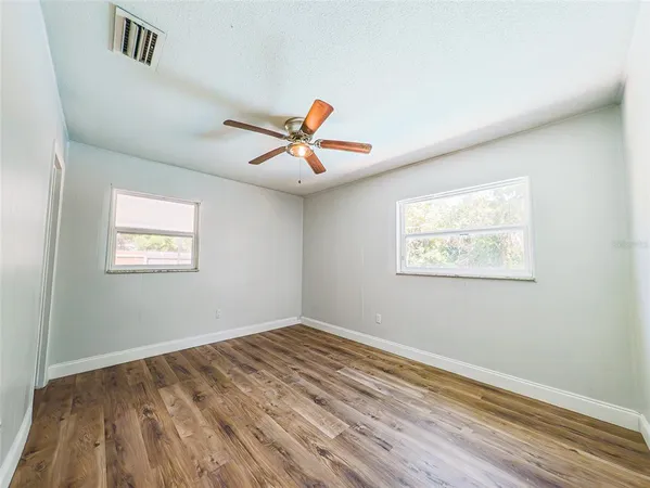 a view of a room with wooden floor and white walls