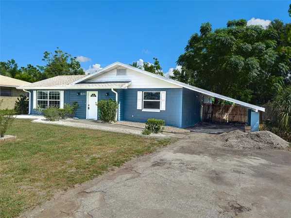 a front view of a house with a garden and yard