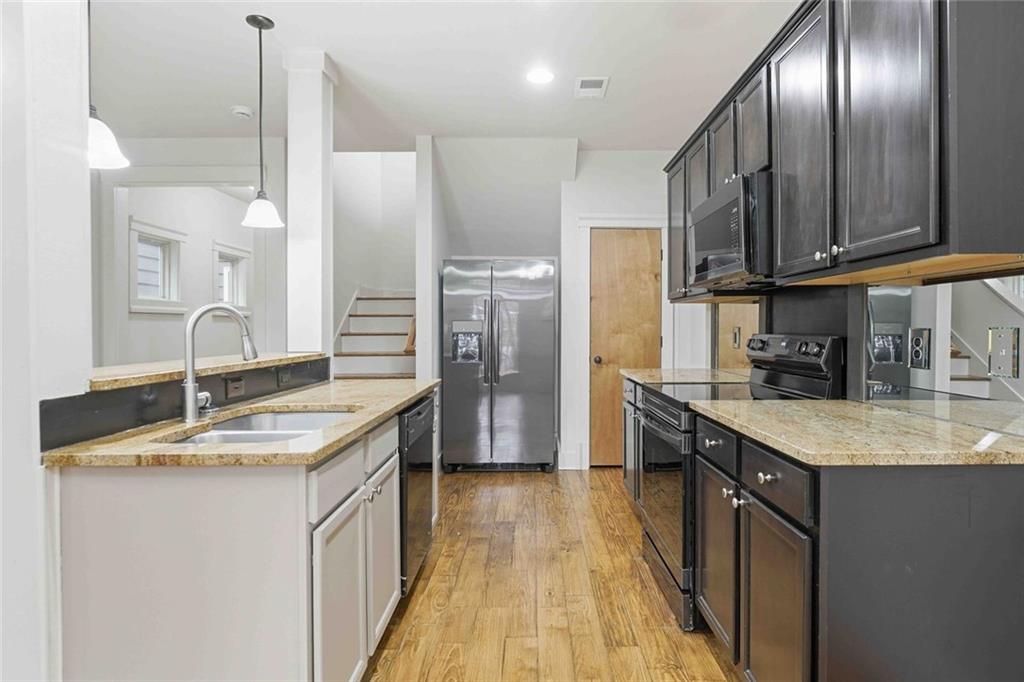 501 Ridge View Crossing Woodstock, GA 30188 - Photo 11 of 44 a kitchen with stainless steel appliances granite countertop a sink a refrigerator and a stove