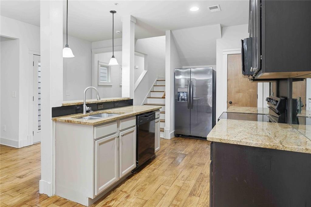 501 Ridge View Crossing Woodstock, GA 30188 - Photo 12 of 44 a kitchen with stainless steel appliances granite countertop a sink a stove and a refrigerator