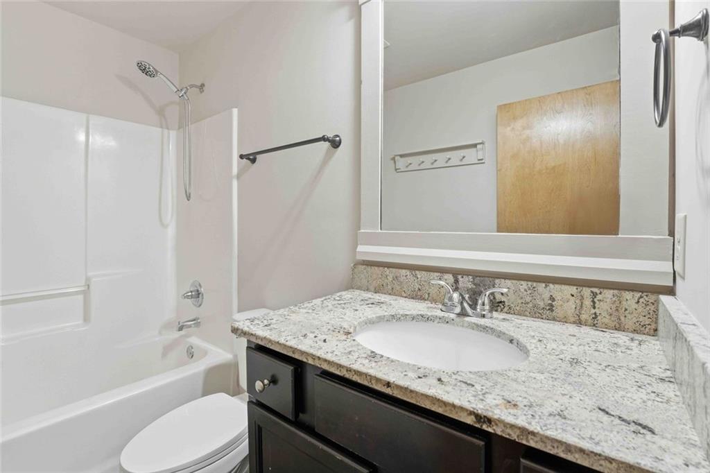 501 Ridge View Crossing Woodstock, GA 30188 - Photo 21 of 44 a bathroom with a granite countertop sink toilet and shower