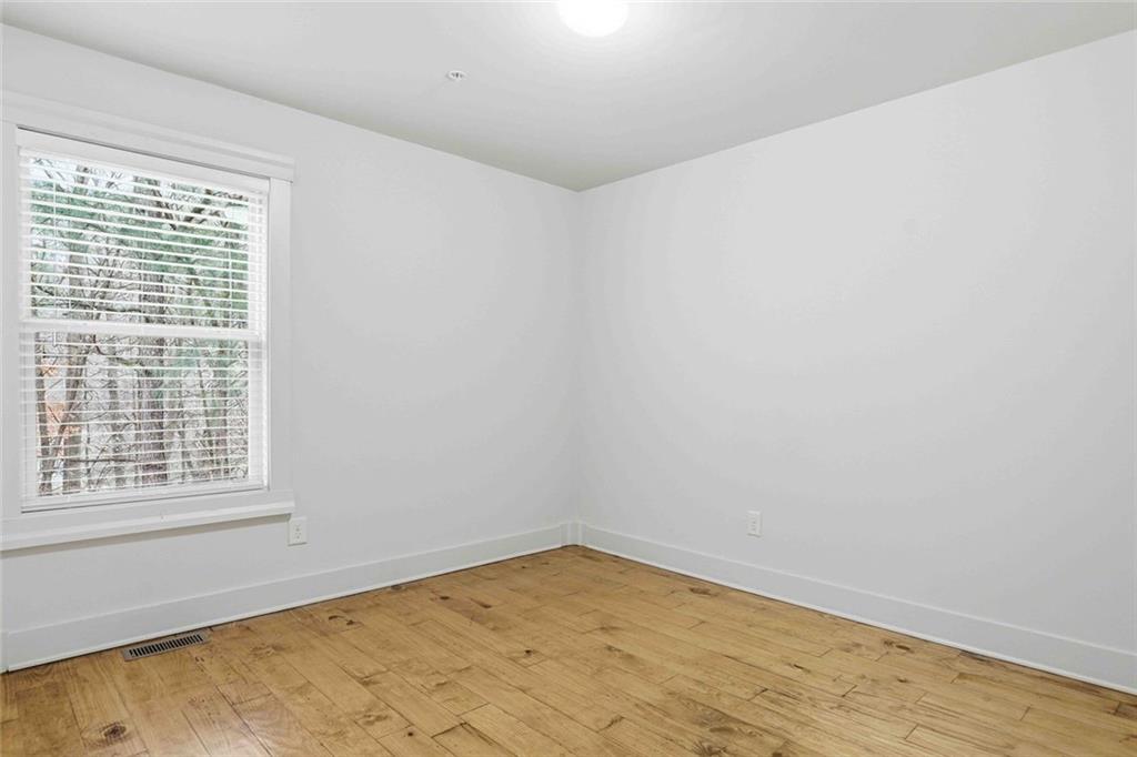 501 Ridge View Crossing Woodstock, GA 30188 - Photo 22 of 44 a view of empty room with wooden floor and fan