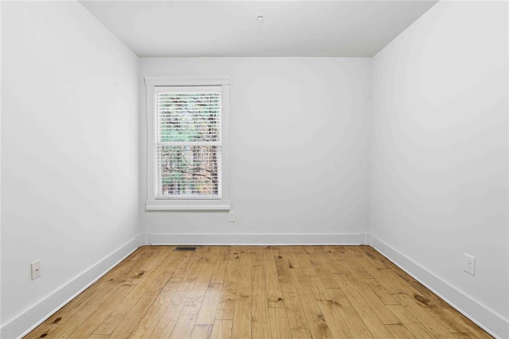 501 Ridge View Crossing Woodstock, GA 30188 - Photo 23 of 44 an empty room with wooden floor and windows