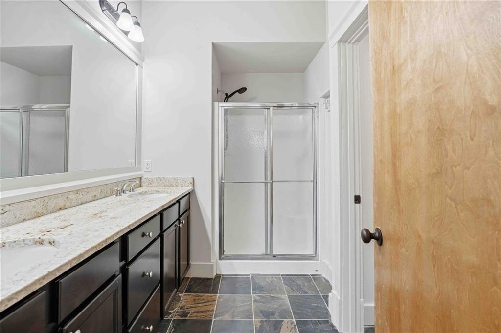 501 Ridge View Crossing Woodstock, GA 30188 - Photo 33 of 44 a bathroom with a granite countertop sink and a mirror