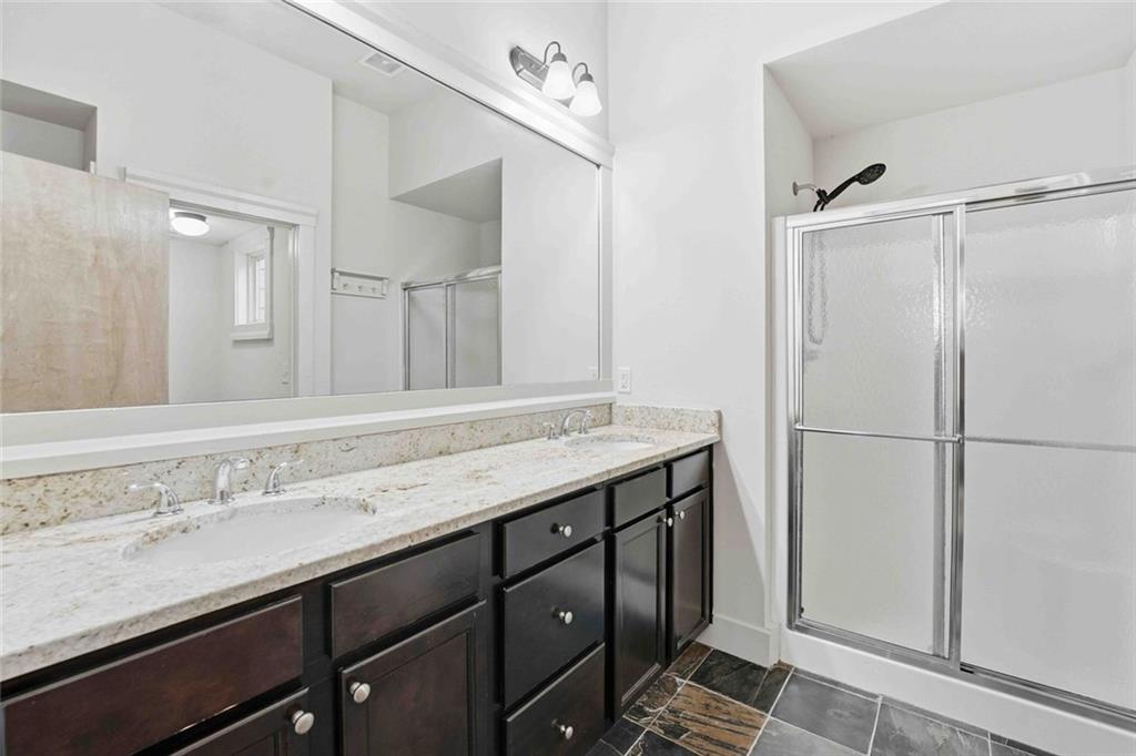 501 Ridge View Crossing Woodstock, GA 30188 - Photo 34 of 44 a bathroom with a granite countertop sink two mirror and a shower