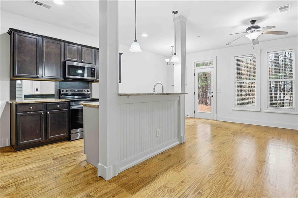 501 Ridge View Crossing Woodstock, GA 30188 - Photo 5 of 44 a large kitchen with stainless steel appliances granite countertop a stove a sink and a refrigerator