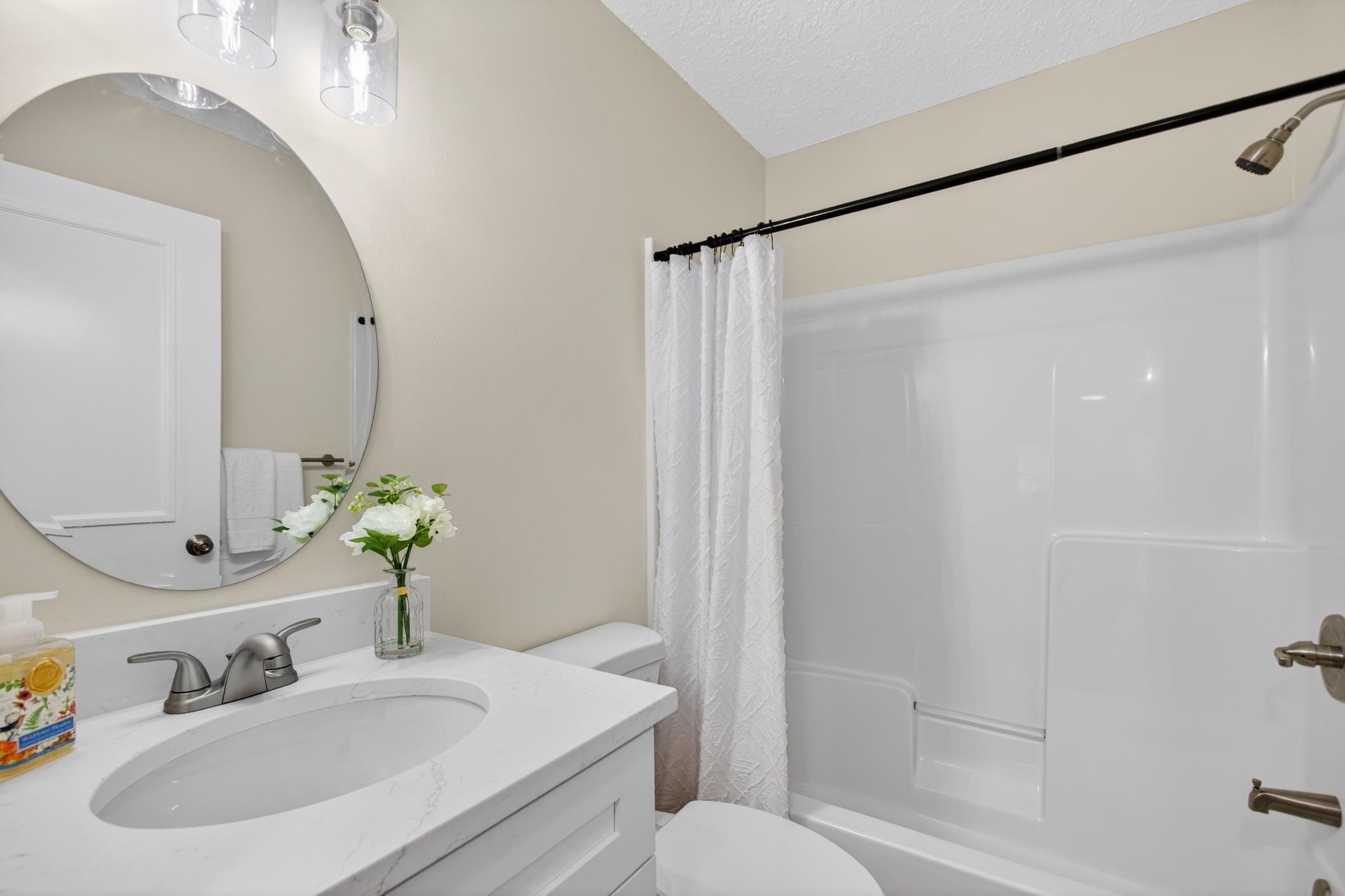 37 Madeore Street St. Augustine, FL 32084 - Photo 35 of 45 Full bathroom featuring new vanity, shower / bath combo, and a textured ceiling.