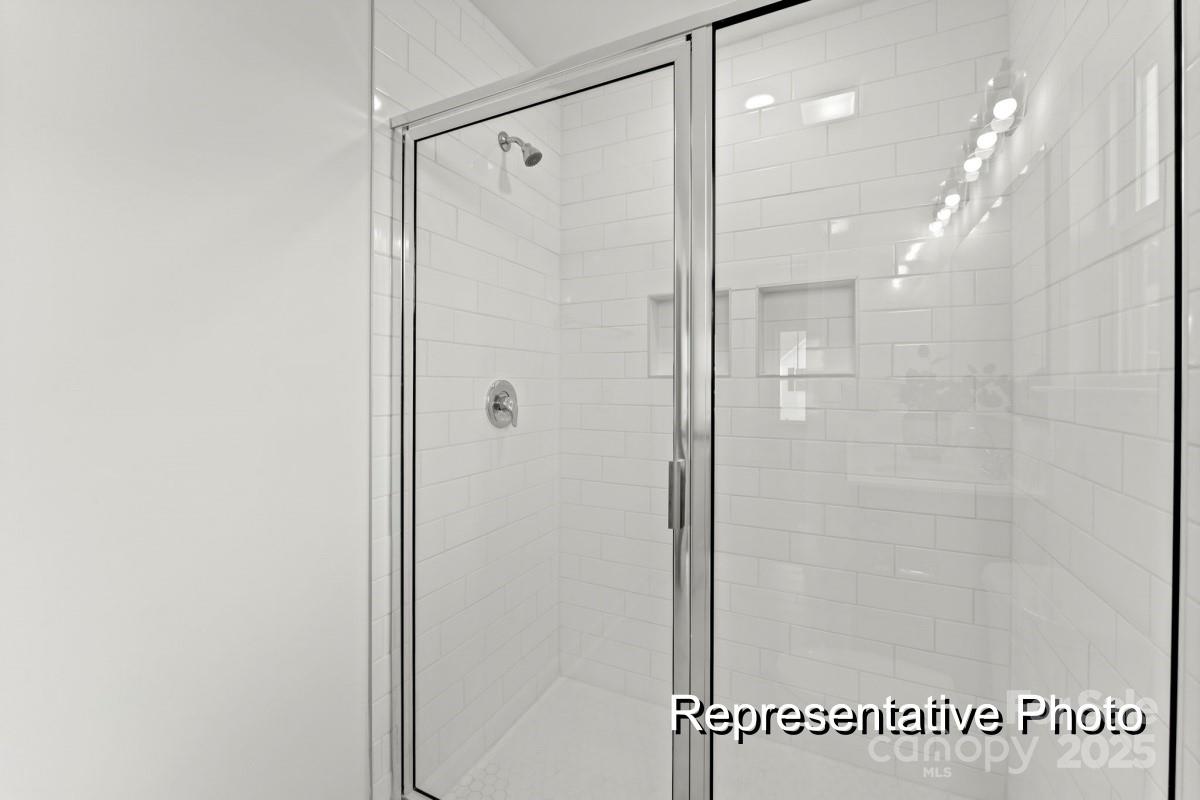 32612 B Millingport Road, Unit 7157 New London, NC 28127 - Photo 19 of 23 a bathroom with a shower and a glass door