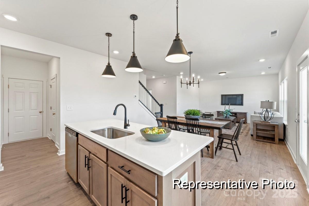 32612 B Millingport Road, Unit 7157 New London, NC 28127 - Photo 2 of 23 a kitchen with a sink a counter and chairs