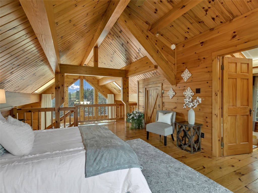 18304 West Reed Park Road Jonestown, TX 78645 - Photo 16 of 24 Rich wood planking and massive exposed trusses define this warm vaulted loft bedroom.