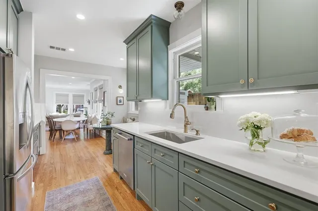 a kitchen with sink and cabinets