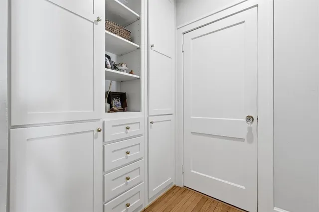 a view of walk in closet with empty racks