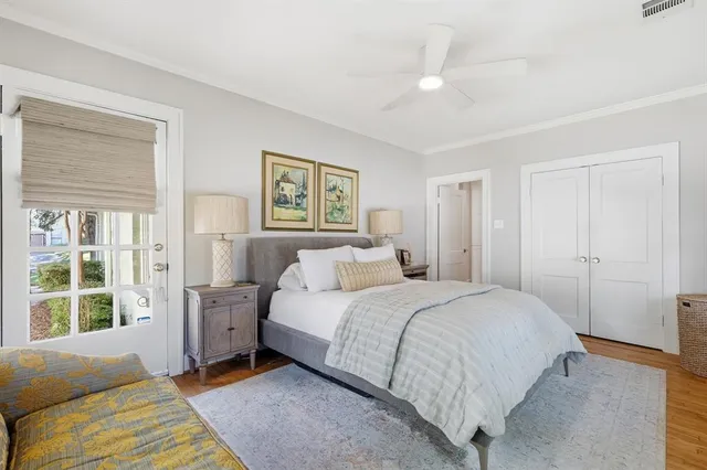 a bedroom with a bed and a large window