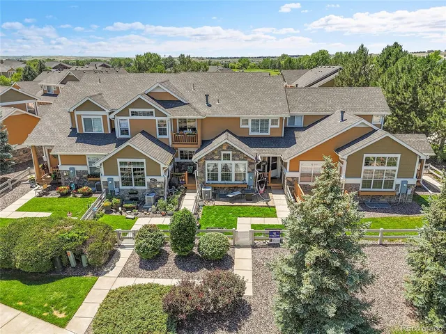 a aerial view of a house with a big yard and potted plants