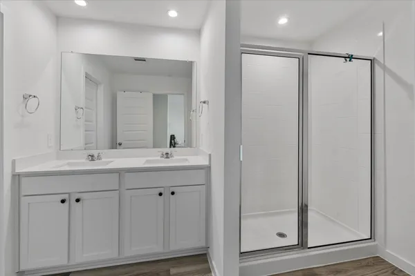 a bathroom with a double vanity sink and mirror