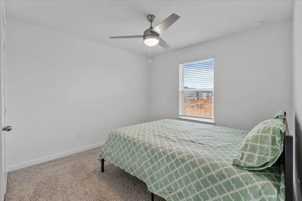 a bedroom with a bed and a window