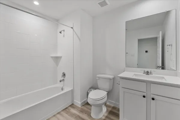 a bathroom with a sink toilet vanity and bathtub
