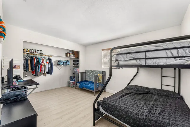 a bedroom with a bed and a chandelier