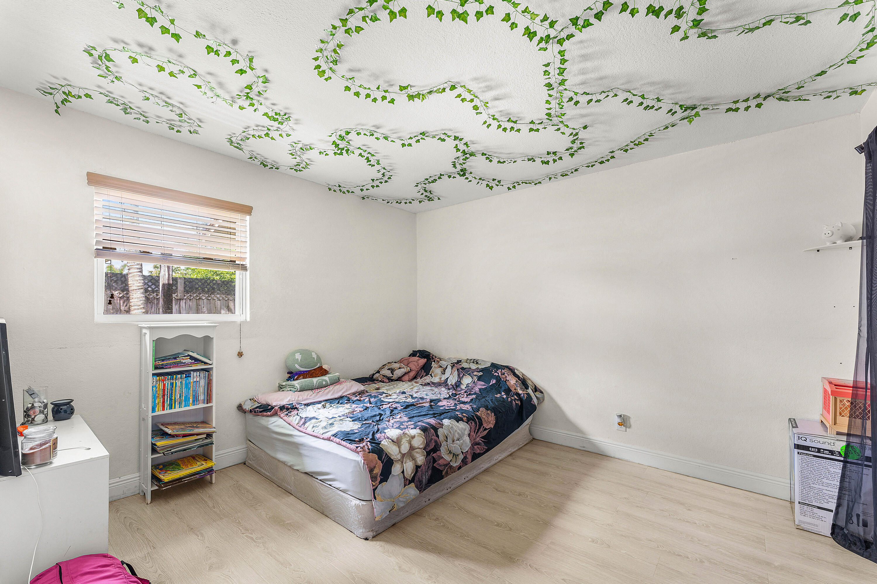 2907 Apalachee Road Palm Springs, FL 33406 - Photo 16 of 27 a bedroom with a bed chandelier and a window