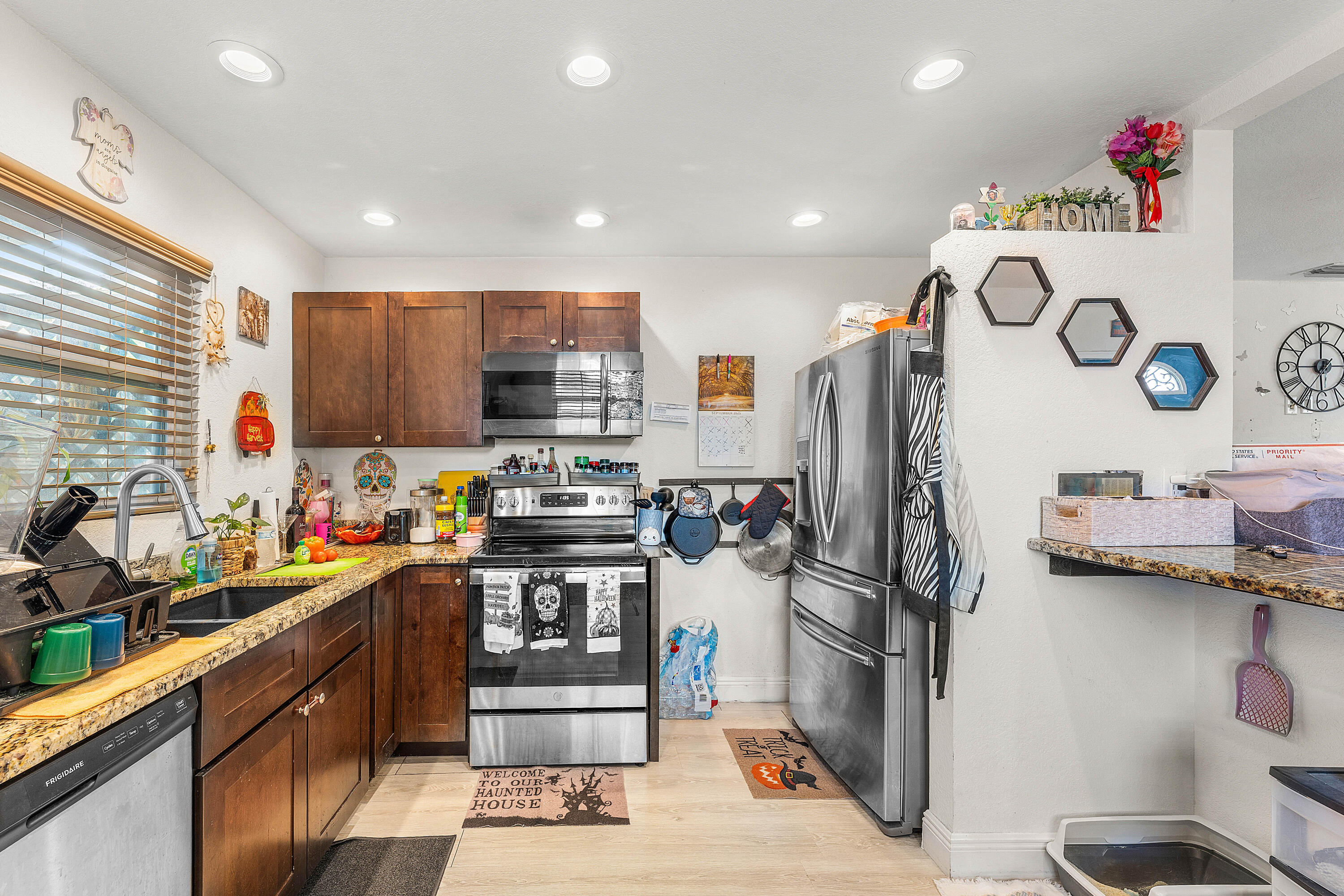 2907 Apalachee Road Palm Springs, FL 33406 - Photo 22 of 27 a kitchen with refrigerator and cabinets