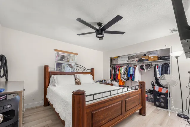 a bedroom with a bed and a chandelier