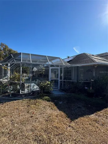 a view of house with yard and sitting area