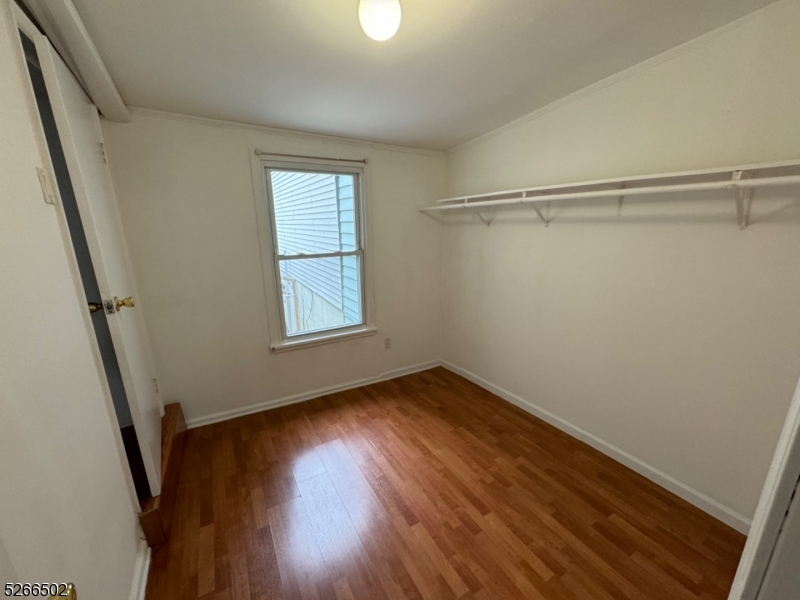 158 Lafayette Street, Unit 2 Newark, NJ 07105 - Photo 13 of 16 a view of a room with wooden floors and stairs