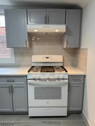 a stove top oven sitting inside of a kitchen