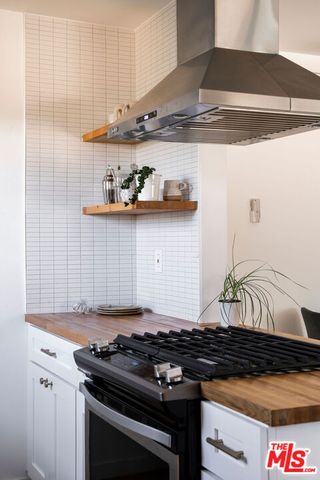a kitchen with stainless steel appliances granite countertop a stove and a sink