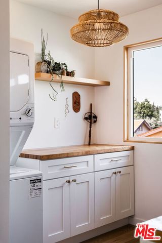 a room with kitchen island a sink a stove and a window
