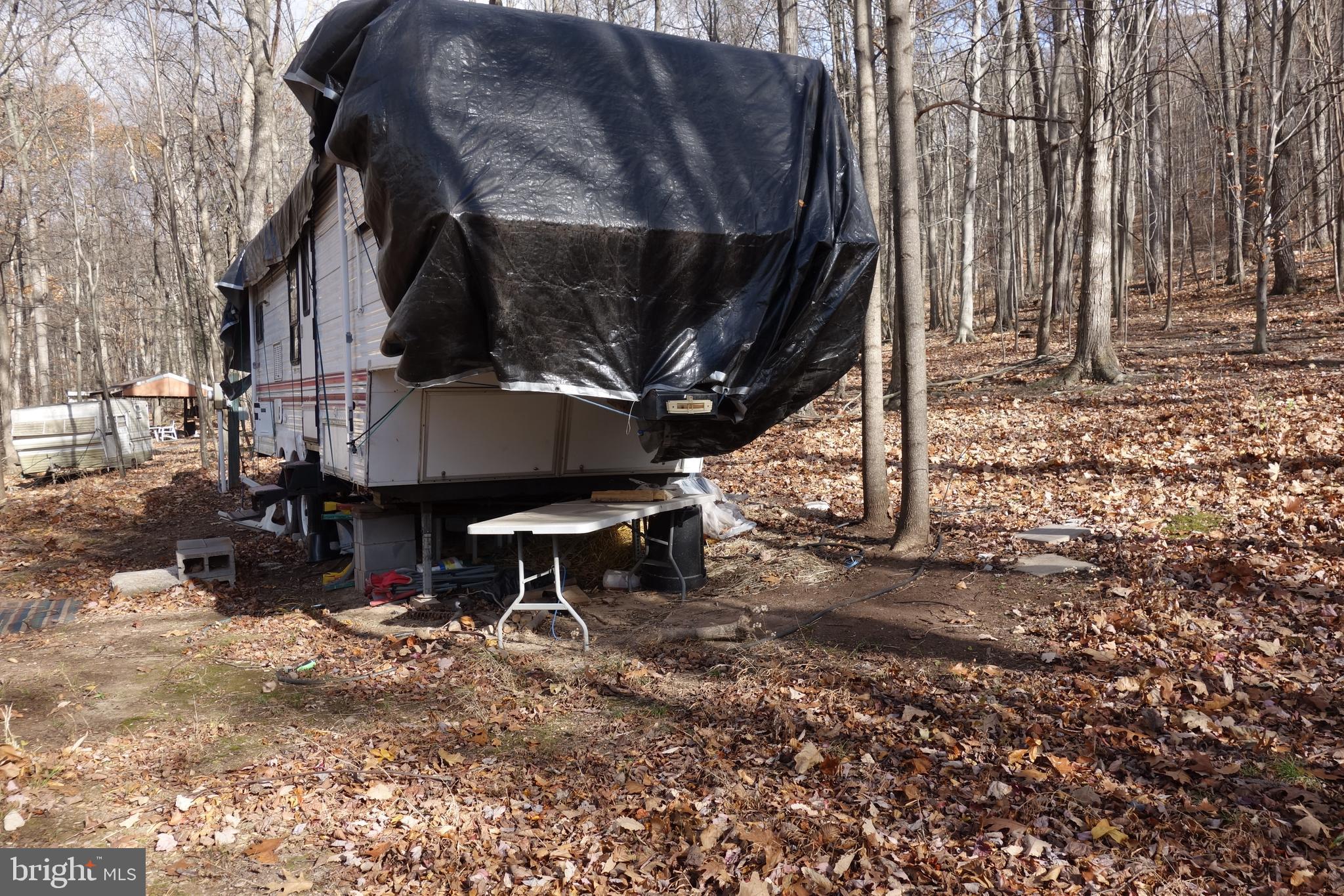 22556 Loop Road Doylesburg, PA 17219 - Photo 4 of 6 a backyard of a house with table and chairs