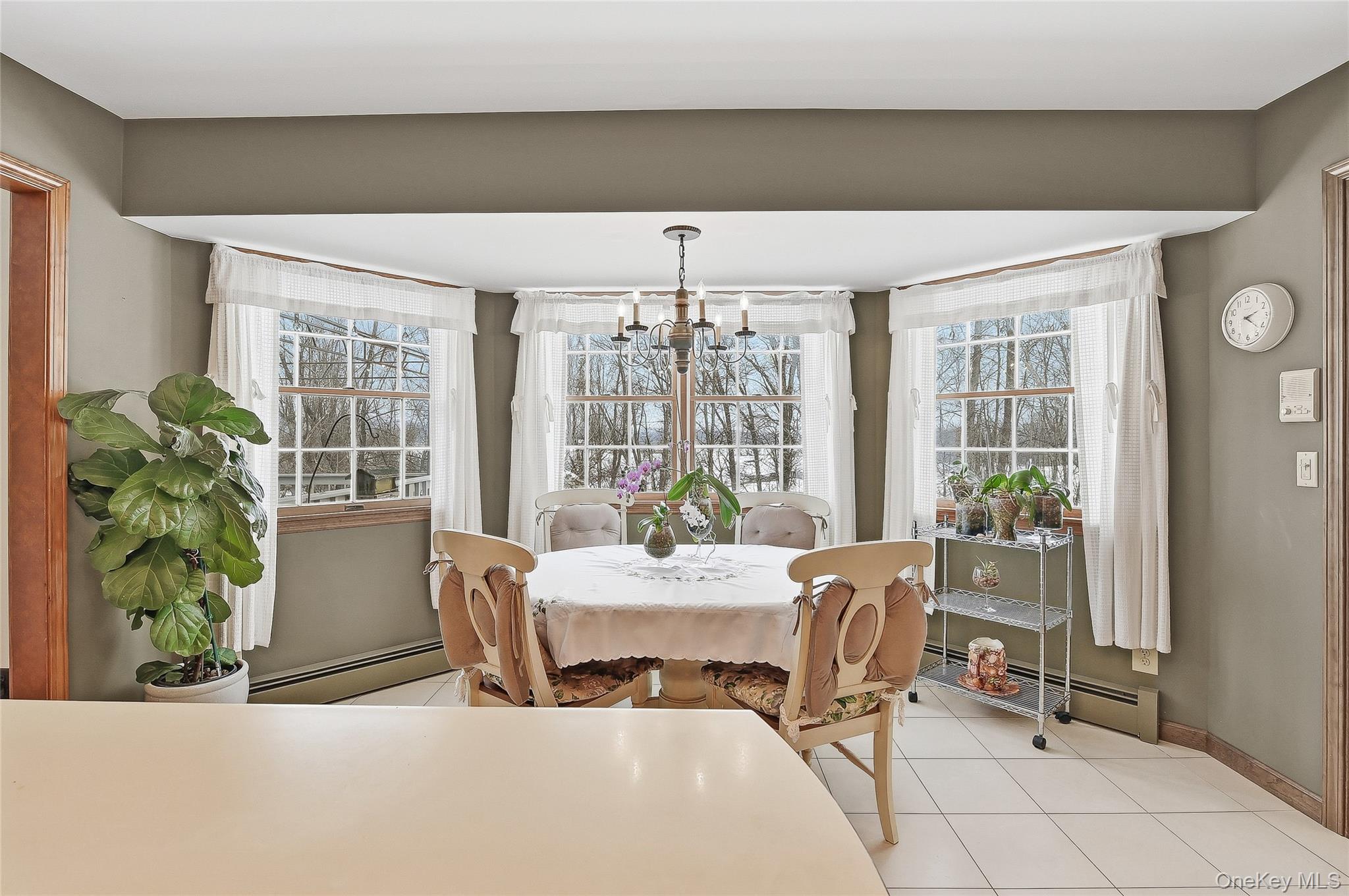 183 High Meadows Road Walden, NY 12586 - Photo 15 of 44 Kitchen with a baseboard radiator, a chandelier, and light tile patterned floors