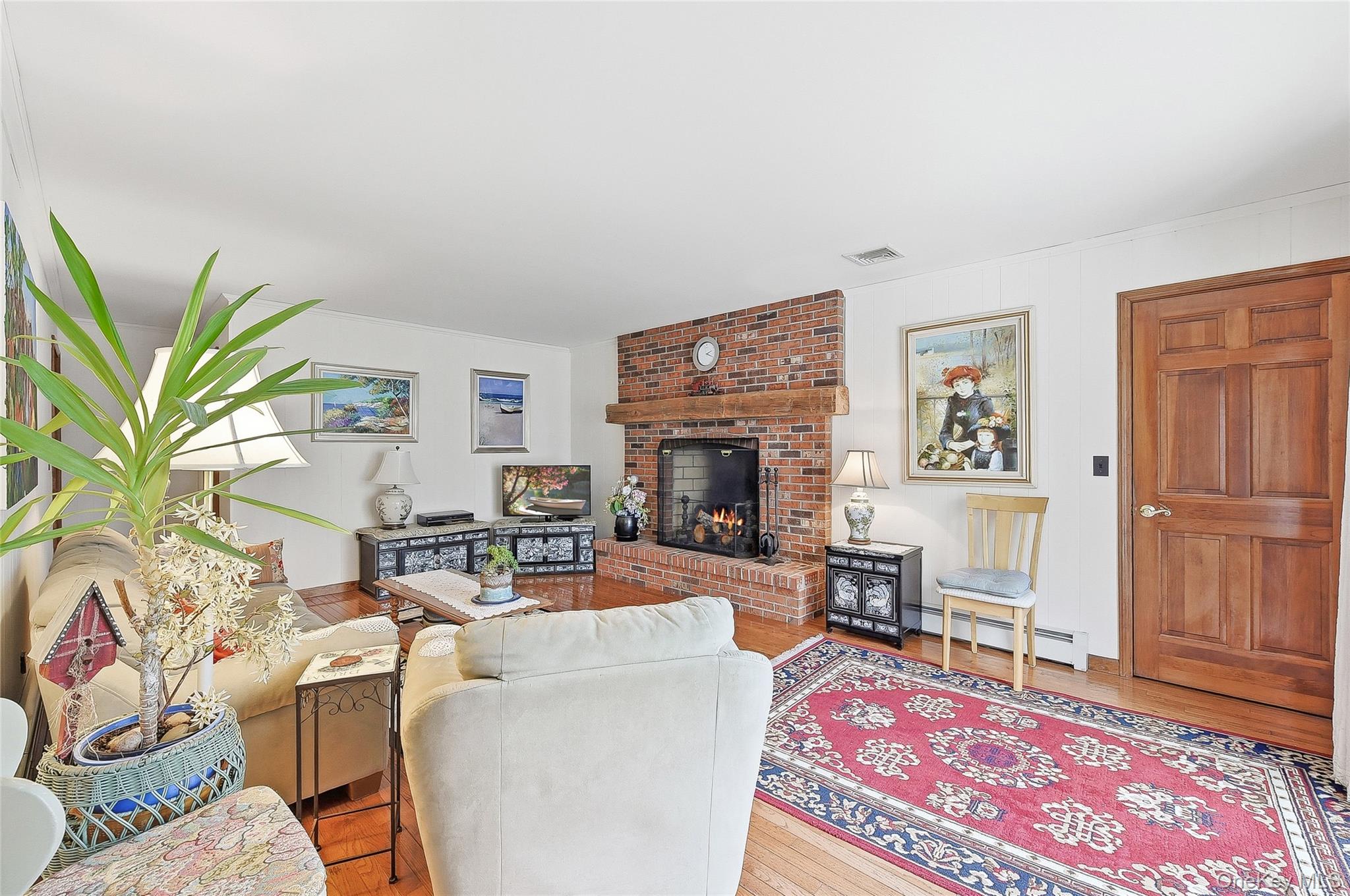 183 High Meadows Road Walden, NY 12586 - Photo 16 of 44 Family room featuring a brick fireplace, and wood flooring