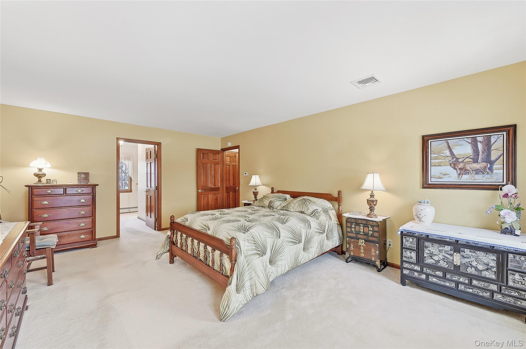 183 High Meadows Road Walden, NY 12586 - Photo 22 of 44 Bedroom featuring light carpet, baseboard heating, and ensuite bath