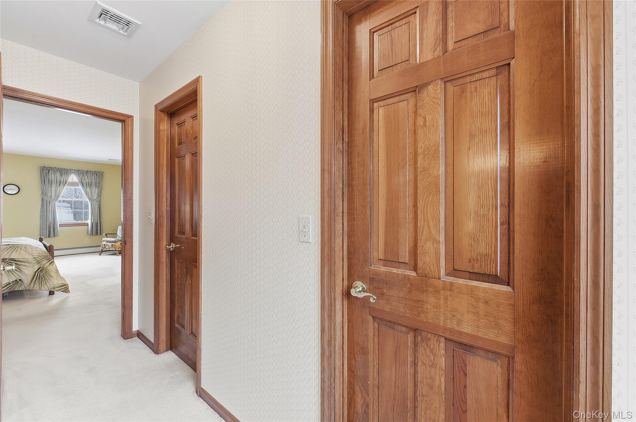 183 High Meadows Road Walden, NY 12586 - Photo 26 of 44 Hallway with wallpapered walls, carpet floors, and a baseboard radiator