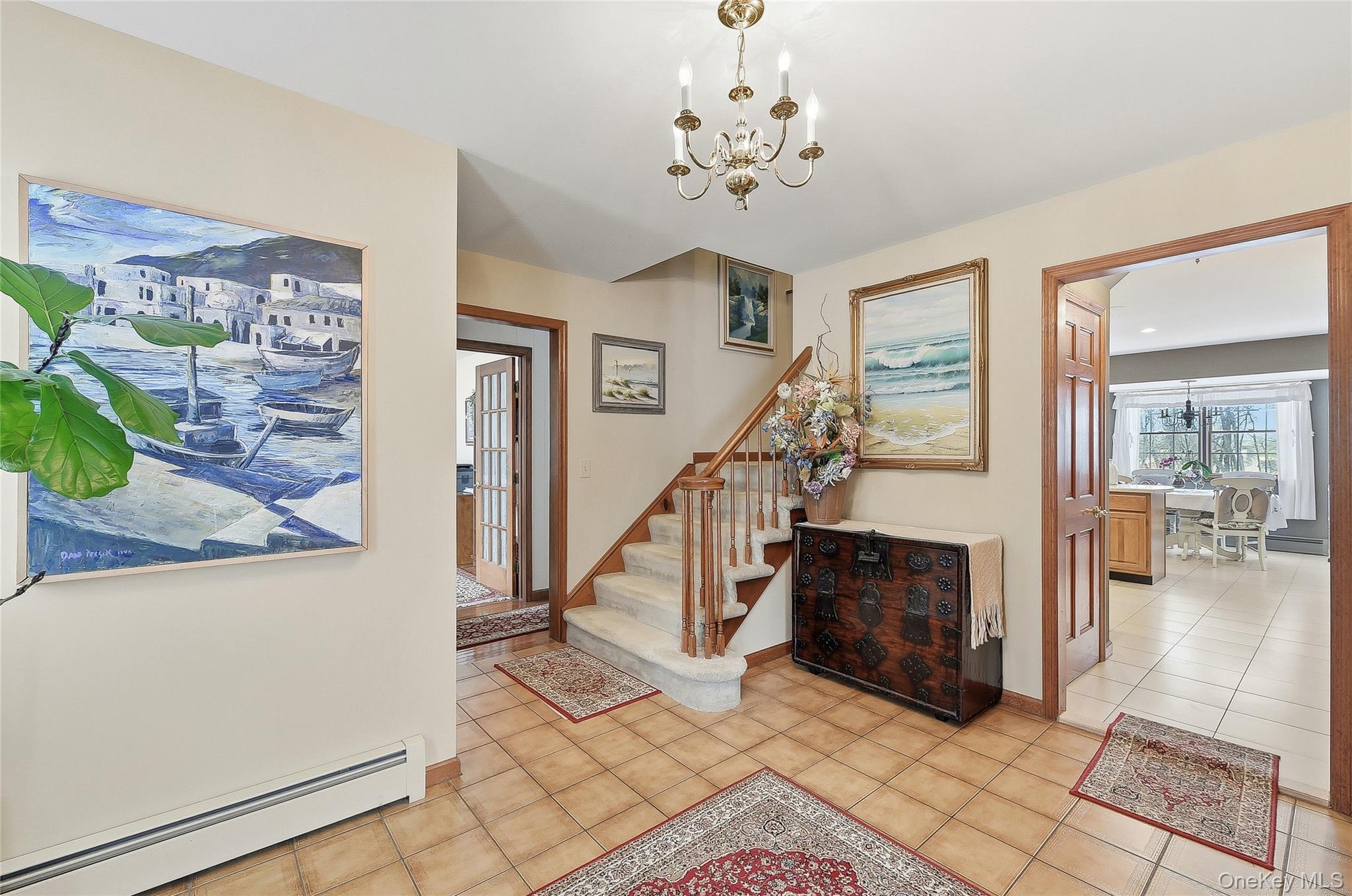 183 High Meadows Road Walden, NY 12586 - Photo 4 of 44 Entrance foyer with a baseboard heating unit, a chandelier, and light tile patterned floors